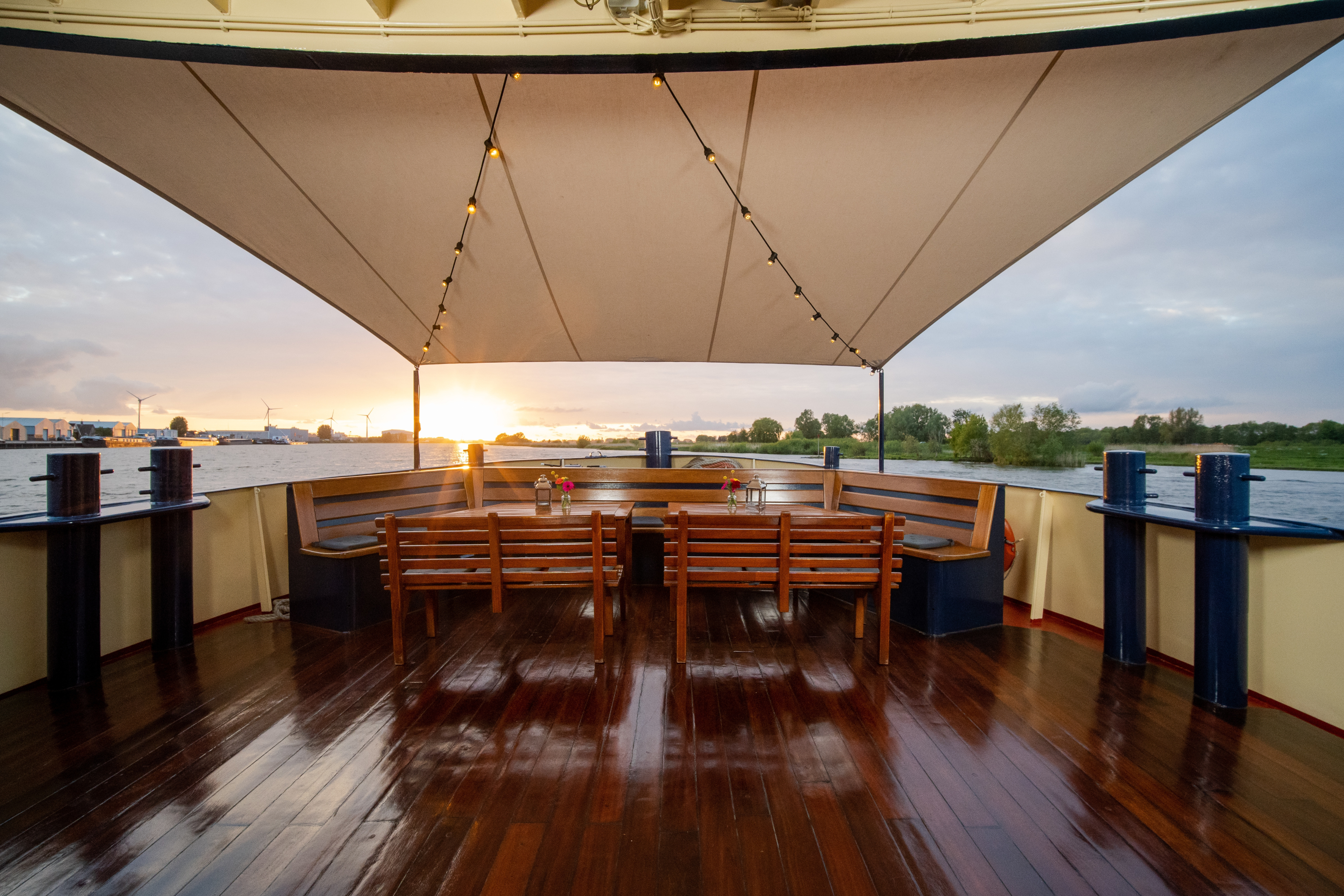 Grand houseboat anchored at golden hour